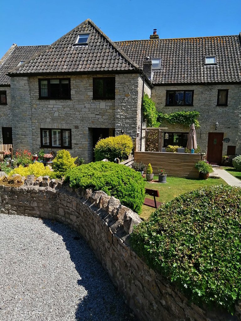 Stone house with garden and blue sky
