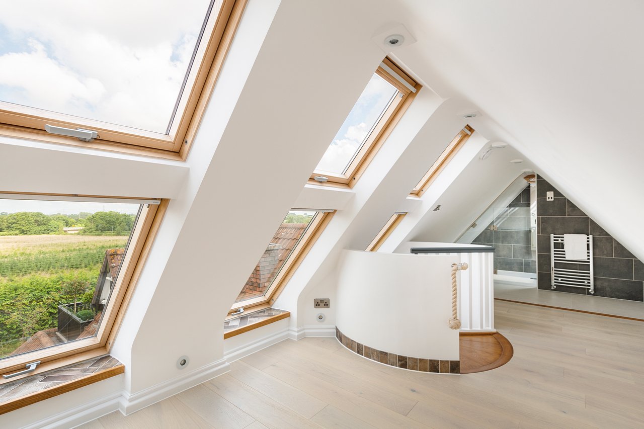 Modern loft conversion with skylights and wooden floor
