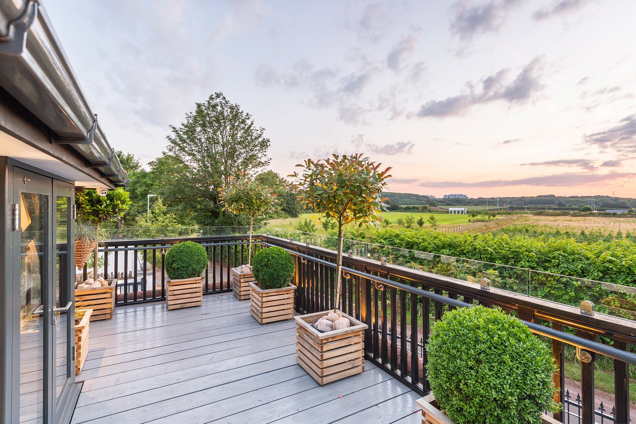 Modern terrace with countryside view at sunset.