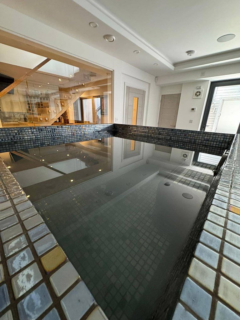 Modern indoor pool in luxurious home setting in basement new build
